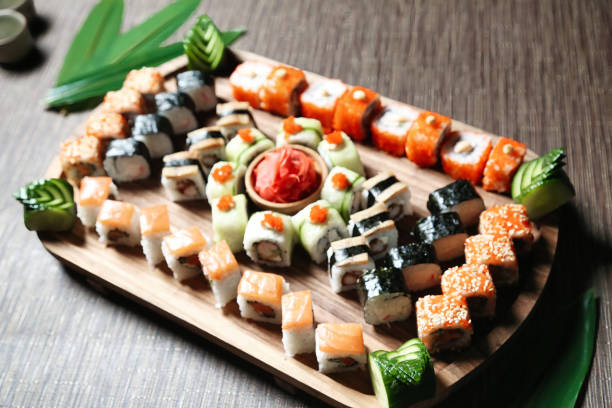 istock Assorted Sushi Types Arranged on Wooden Tray 2119010976