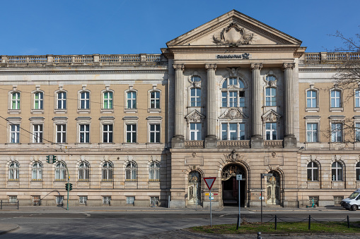 Potsdam, Germany - March 20, 2024:  Deutsche Post building with signage and logo on historic facade.
