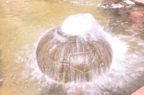 Water gushes from a decorative circular fountain in the pond. Eskisehir, Turkey. 09/17/2017