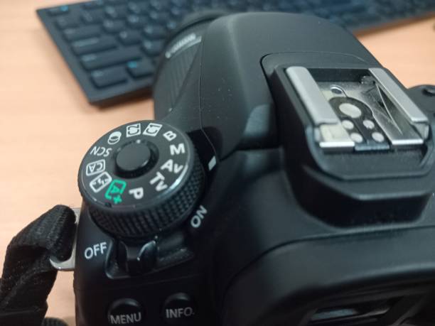 istock Black DSLR camera photo complete with lens 2119038284