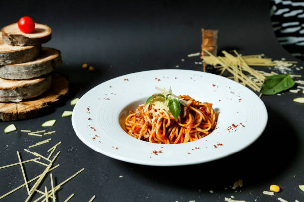 istock Plate of Spaghetti With Tomato Sauce on Black Table 2119064677