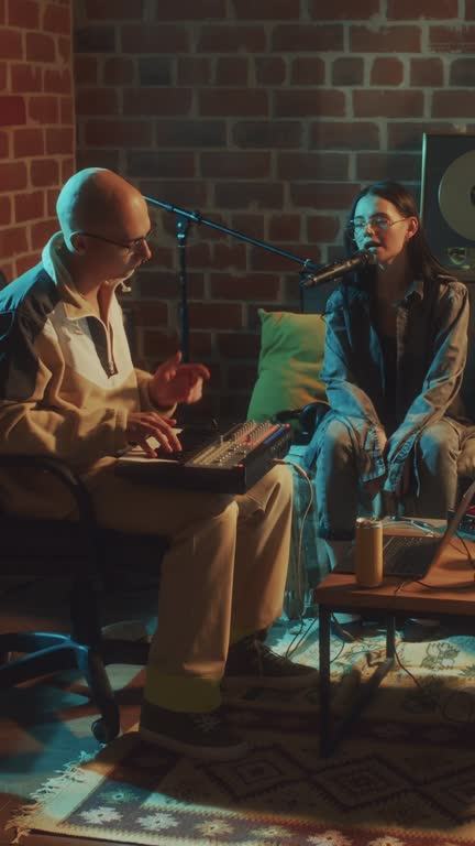 Vertical of Indie Band Rehearsing Song to Guitar in Retro-Style Room