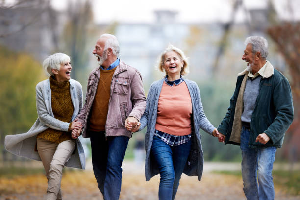 istock Carefree senior couples having fun while running in nature. 2119093781