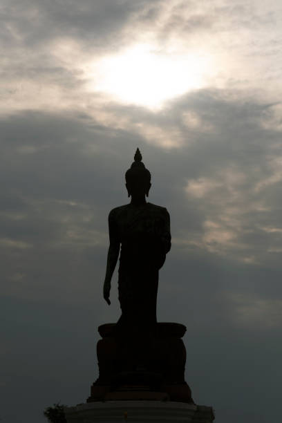 istock Silhouette of a large Buddha statue with a beautiful sky and clouds in the Phutthamonthon district, Thailand 2119099615