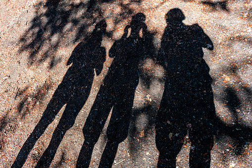 shadow of three people