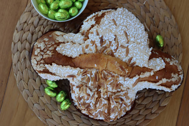 istock Sweet Easter cake named Colomba Pasquale (Easter dove) with chocolate eggs on table 2119123938