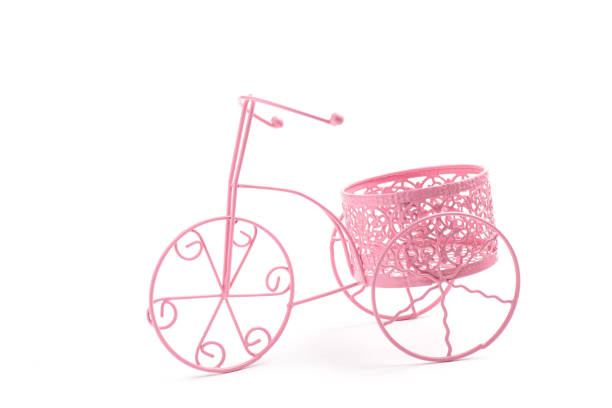 Small decorative bicycle isolated on white background. Craftsmanship in metal.