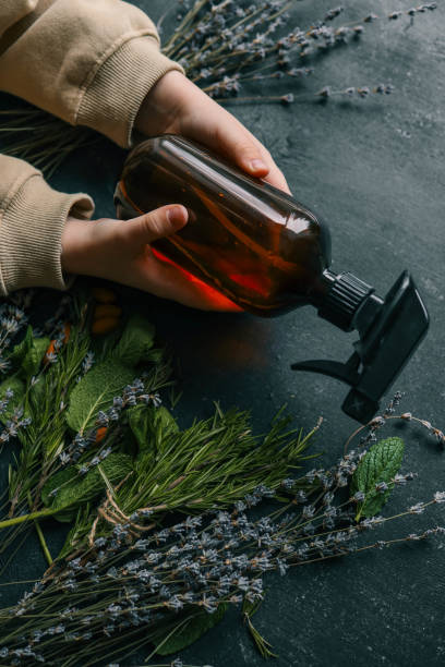 istock Natural spray for hair growth with herbs in hands 2119169668