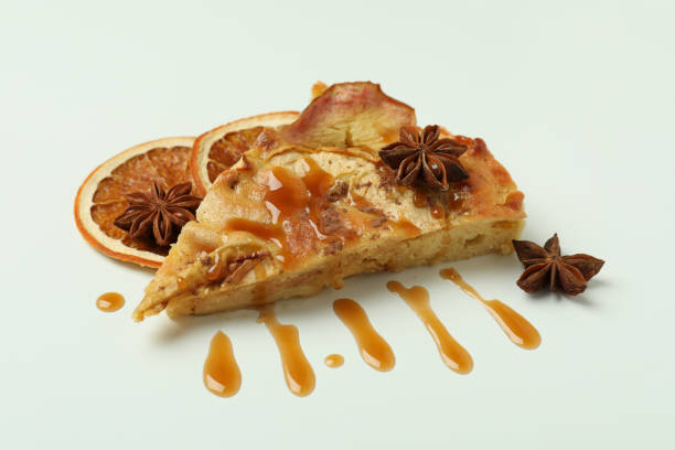 istock Piece of apple pie with caramel on white background 2119203308