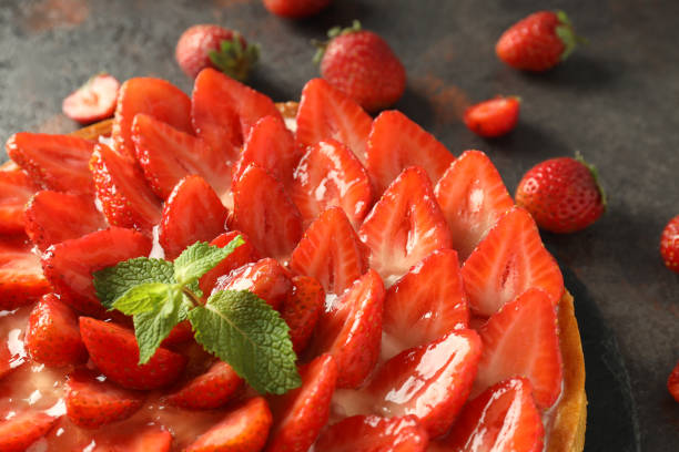 istock Tray with strawberry tart on dark textured table 2119215792