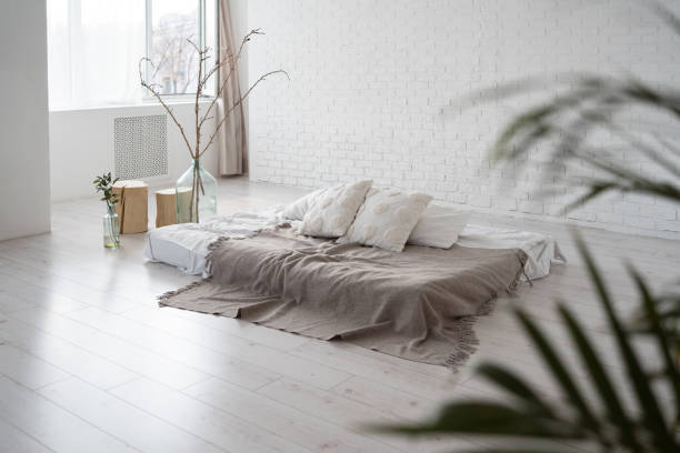 istock modern cozy living room with mattress on floor 2119225643