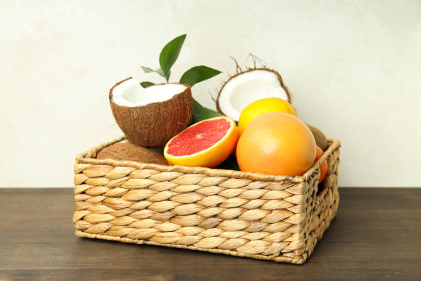 istock Basket with exotic fruits on wooden table 2119232127