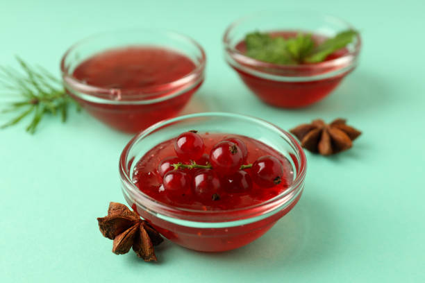 close-up of fresh ripe red currants in a jar on white background