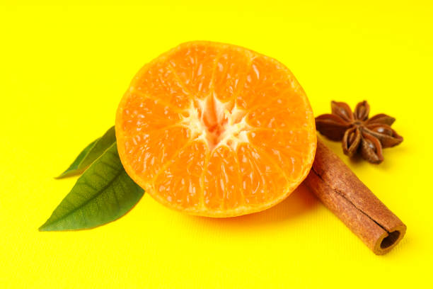 istock Mandarin with leaves and cinnamon on yellow background 2119241963
