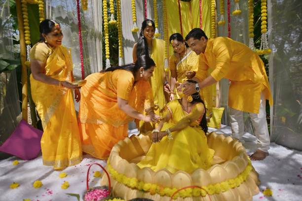 istock Parents applying turmeric paste to the bride (daughter) during the haldi ceremony 2119242492
