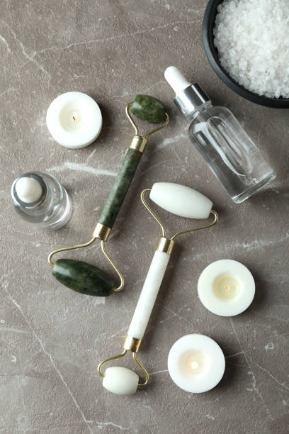 istock Skin care concept with face rollers on gray textured table 2119255523