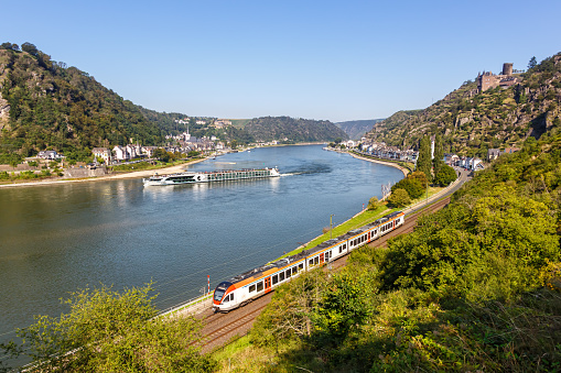 Stadler Flirt regional train operated by VIAS rail at Rhine river, Katz castle and Loreley in St. Goarshausen, Germany
