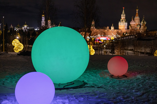 Colorful balls on the background of Moscow Kremlin at night.