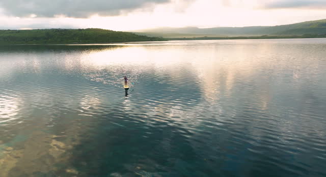 Woman Rowing A Paddleboard On A Lake In Moso Island, Vanuatu - Aerial Drone Shot