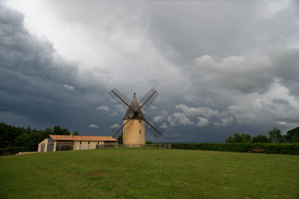 Windmills in the countryside with very cloudy sky and storm.