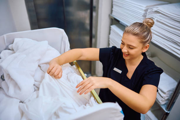 istock Happy maid working in laundry room at the hotel. 2119345462