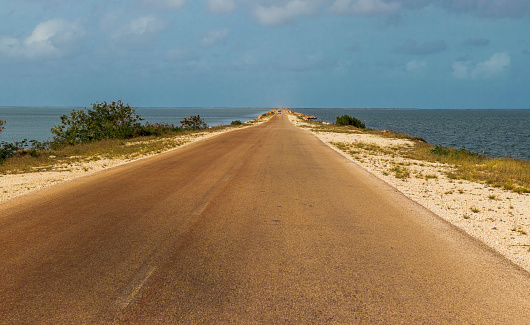 Concept shot of an empty road heading towards the ocean