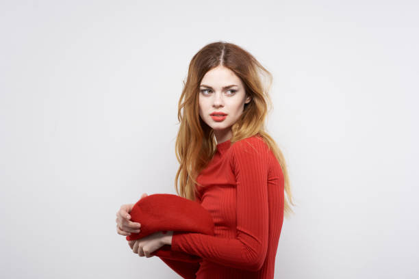 pretty woman with a red cap on his head glamor light background. High quality photo
