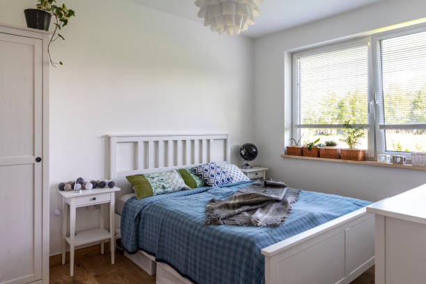 istock Cosy domestic room with comfortable bed with pillow near window. 2119415310