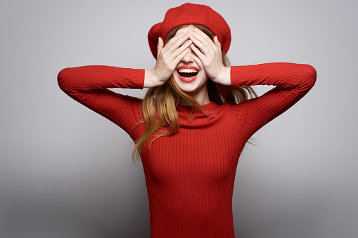 beautiful woman with a red cap on his head glamor isolated background. High quality photo