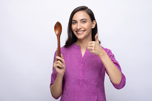 Portrait of young woman chef wear kurta isolated white color background