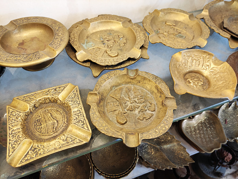 Traditional Oriental Arabic metal plates with decorative pattern on the shop a window