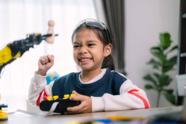 istock Asian girls were learning robot programming and getting lessons control on robot arms. Laboratory. Mathematics, engineering, science, technology, computer code, coding. STEM education. 2119505081