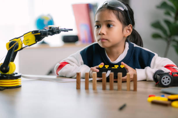 istock Asian girls were learning robot programming and getting lessons control on robot arms. Laboratory. Mathematics, engineering, science, technology, computer code, coding. STEM education. 2119505087