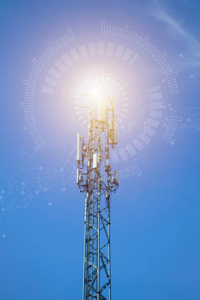 istock a tower with antennas that broadcasts a signal against a blue sky with clouds, wireless telecommunication technology, blending with particles, glittering particles. Connection and mesh dots. 2119505622
