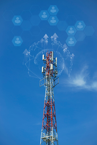 a tower with antennas that broadcasts a signal against a blue sky with clouds, wireless telecommunication technology, Global connection and internet.
