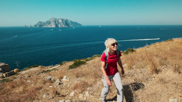 Senior woman hiking Sorrentino Ridge, Italy