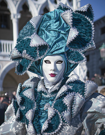 Venice, Italy – March 03, 2022: The Carnival Parade in Venice, Italy on March 3th 2022. In that image a mysterious woman with a detailed silk dress.