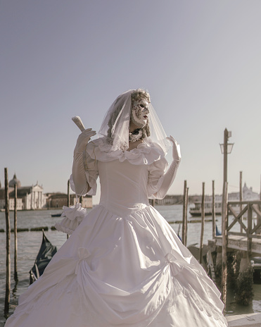 Venice, Italy – March 03, 2022: The Carnival Parade in Venice, Italy on March 3th 2022. In that image a Bride is looking  for her betrothed in the large crowd