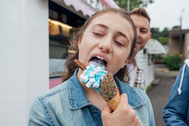 Enjoying Some Ice Cream Close-up shot of a girl eating ice cream. The ice cream is blue and pink with marshmallows and a flake. The girl has her eyes closed as she licks some of the ice cream. They are in Morpeth in the NorthEast of England.
Videos are available similar to this scenario. licking ice cream cone stock pictures, royalty-free photos & images