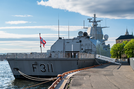 Navy frigate moored at naval dockyard.