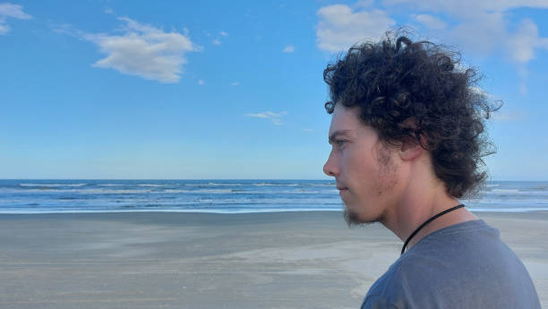 istock young man on the beach 2119555118