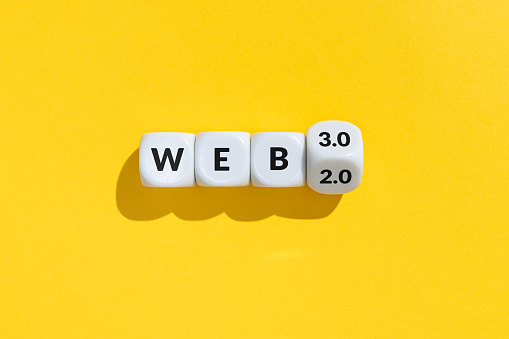 From web 2 to web 3 concept. Cube blocks with text isolated on yellow background