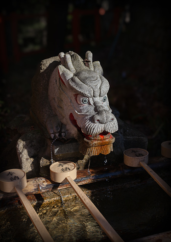 Kyoto, Japan - Dec 29, 2023: Dragon washbasin at Fushimi Inari shrine