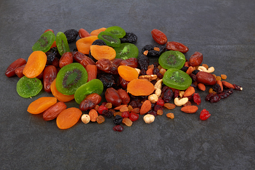 Dry fruits on a black stone background