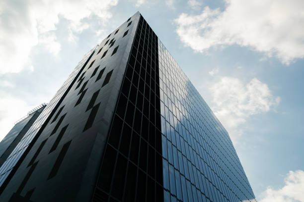 istock modern skyscraper with glass windows in blue sky 2119616313