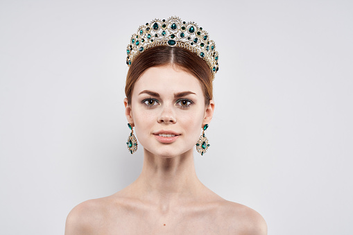 Princess naked shoulders jewelry cosmetics attractive look isolated background. High quality photo