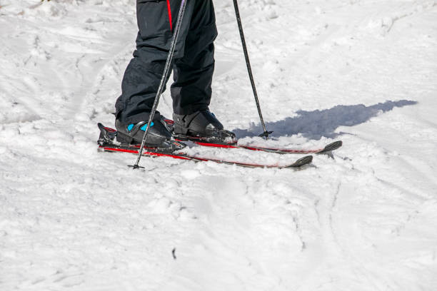 istock skier on a ski slope illuminated by the sun. Leisure 2119644354