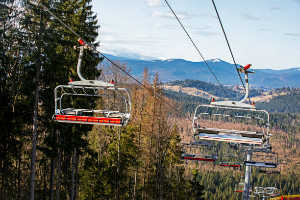 istock empty chairs on a ski lift on a sunny day on a snowy slope. Leisure 2119650636