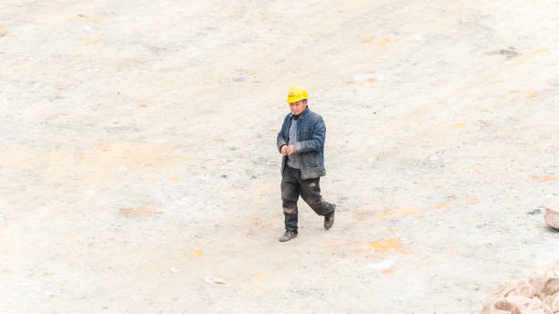 Studio shot of handsome multi ethnic man construction worker against colored background