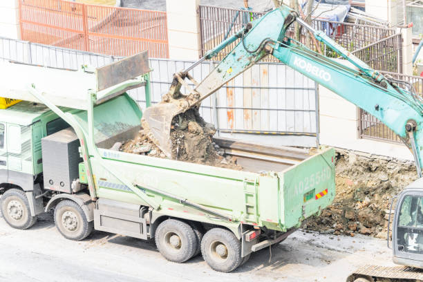 Articulated truck transporting an excavator on a highway in Spain. Concept: transport of construction machinery by road